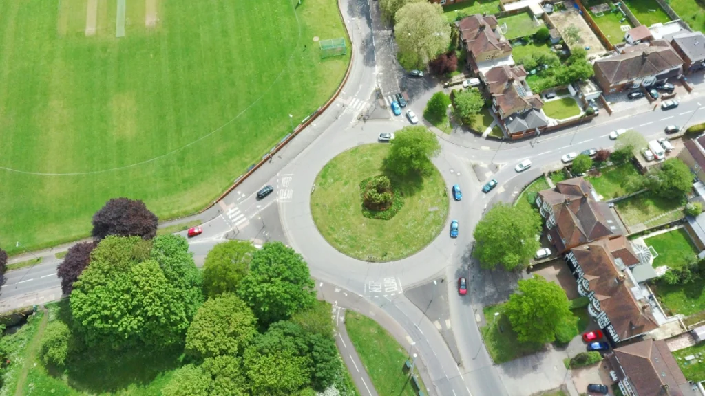 A picture of cars navigating a roundabout junction